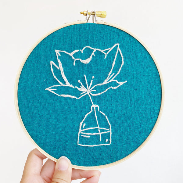 embroidery of a flower in a bottle