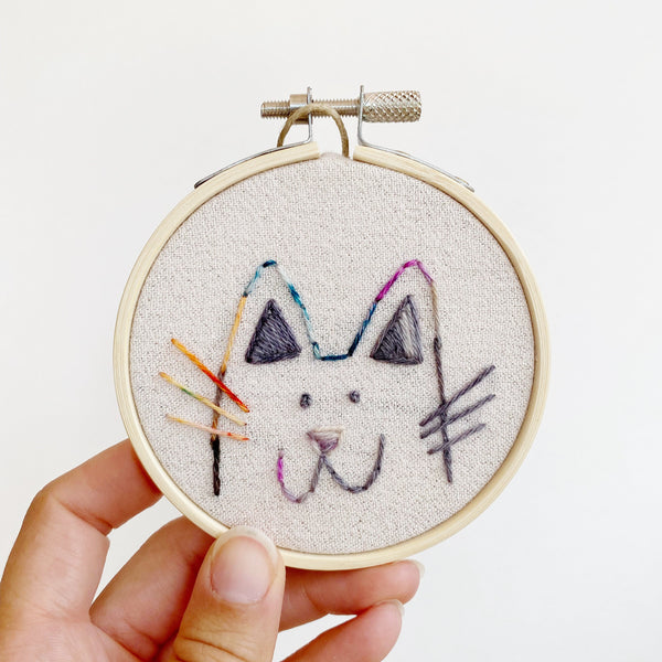 colorful cat embroidery on silver cotton