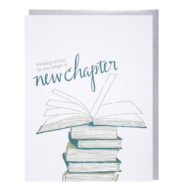 Greeting card with pile of books and text that reads "think of you as you begin a new chapter"