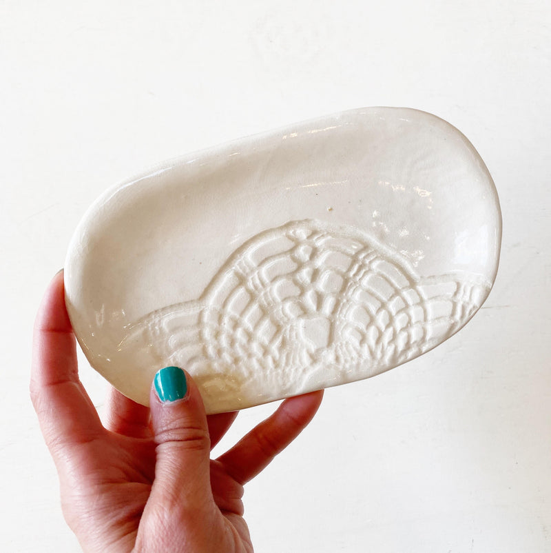 White ceramic soap dish with lace pattern